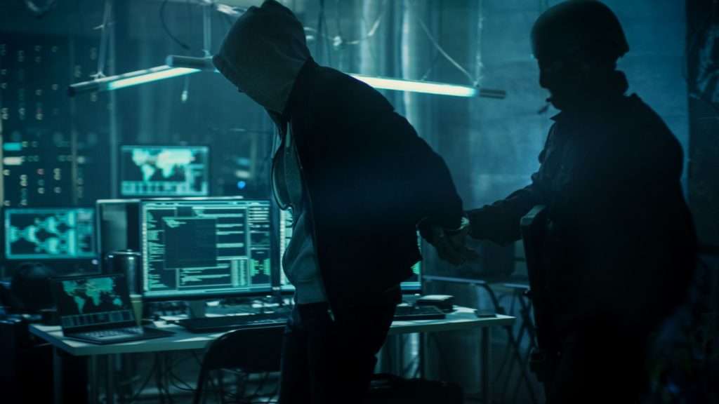 Man being arrested for cybercrimes