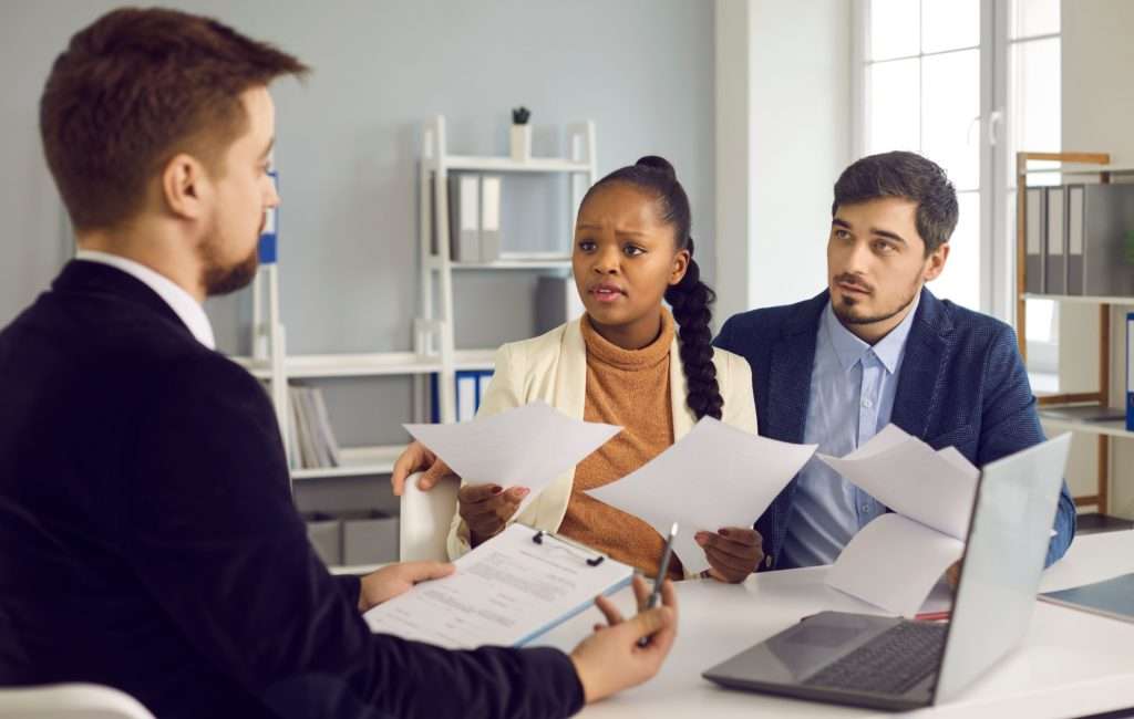 Woman and Man sitting with Lawyer
